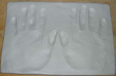 Making hand prints in clay